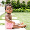 little girl wearing the happy nappy pink dotty reusable swim diaper