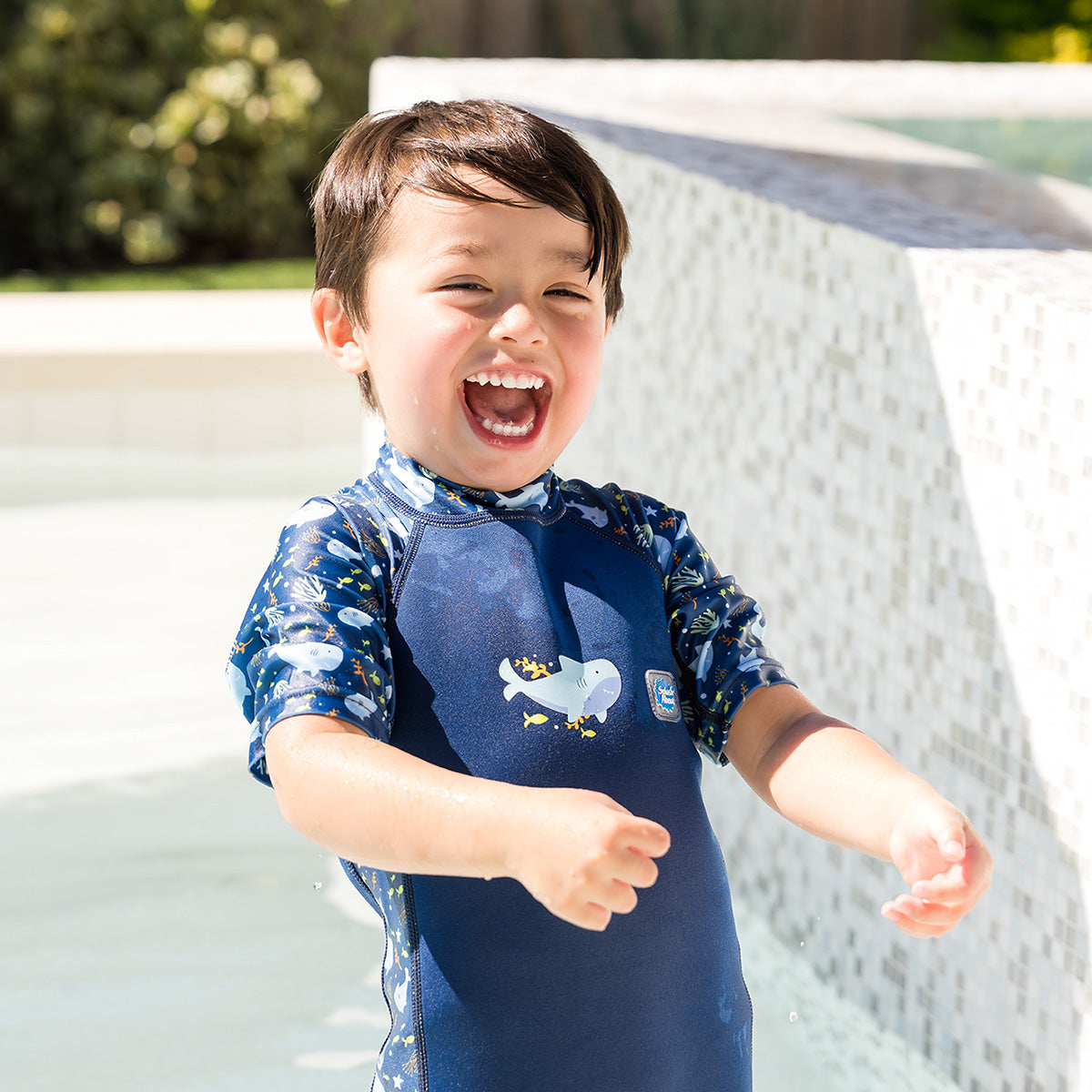 splash about uv sun and suit shark reef little boy laughing near pool