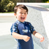 splash about uv sun and suit shark reef little boy laughing near pool