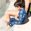splash about uv sun and sea wetsuit shark reef little boy sat at the side of a pool